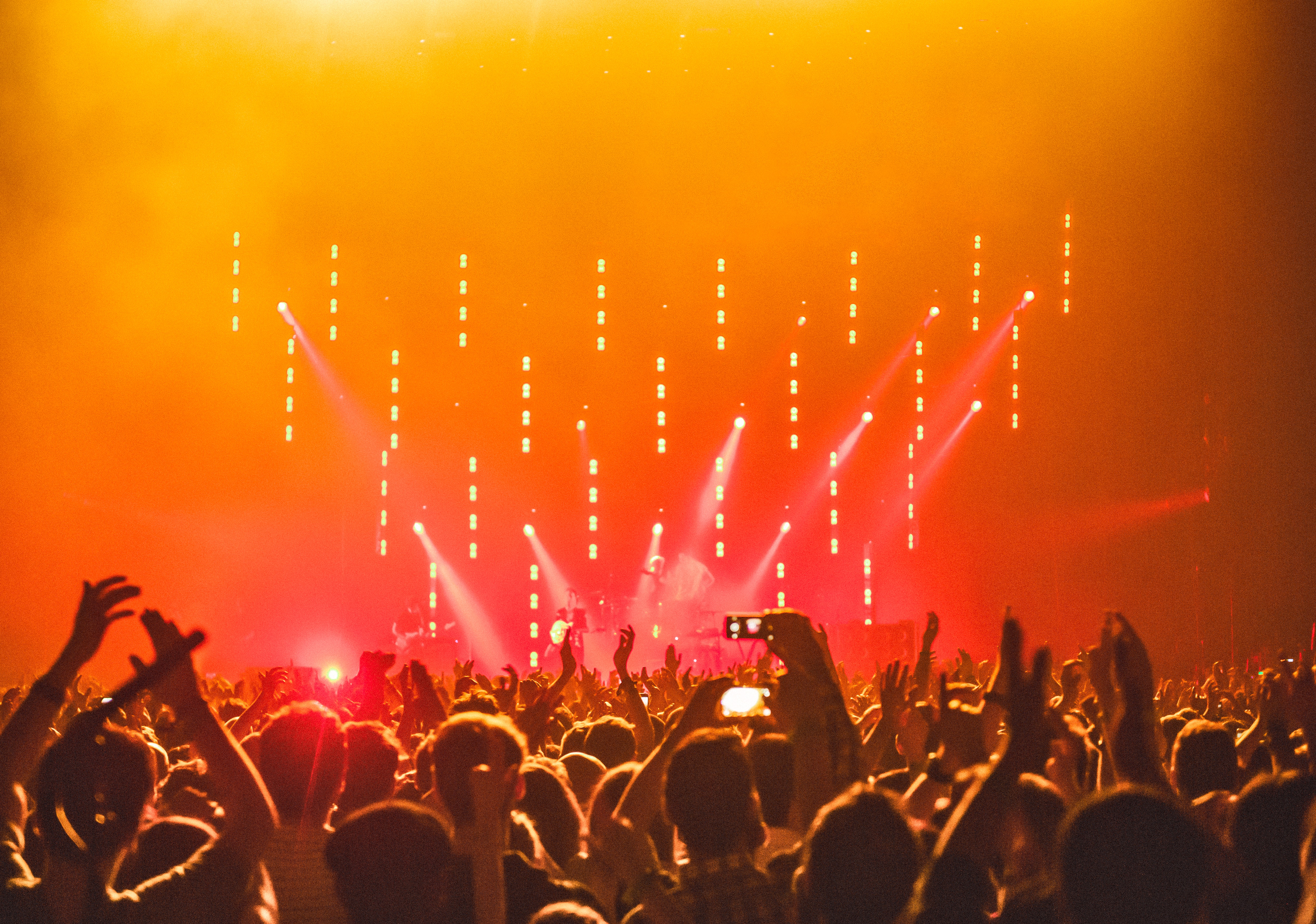 concert with red and orange lights; Photo by anna-m. w. from Pexels