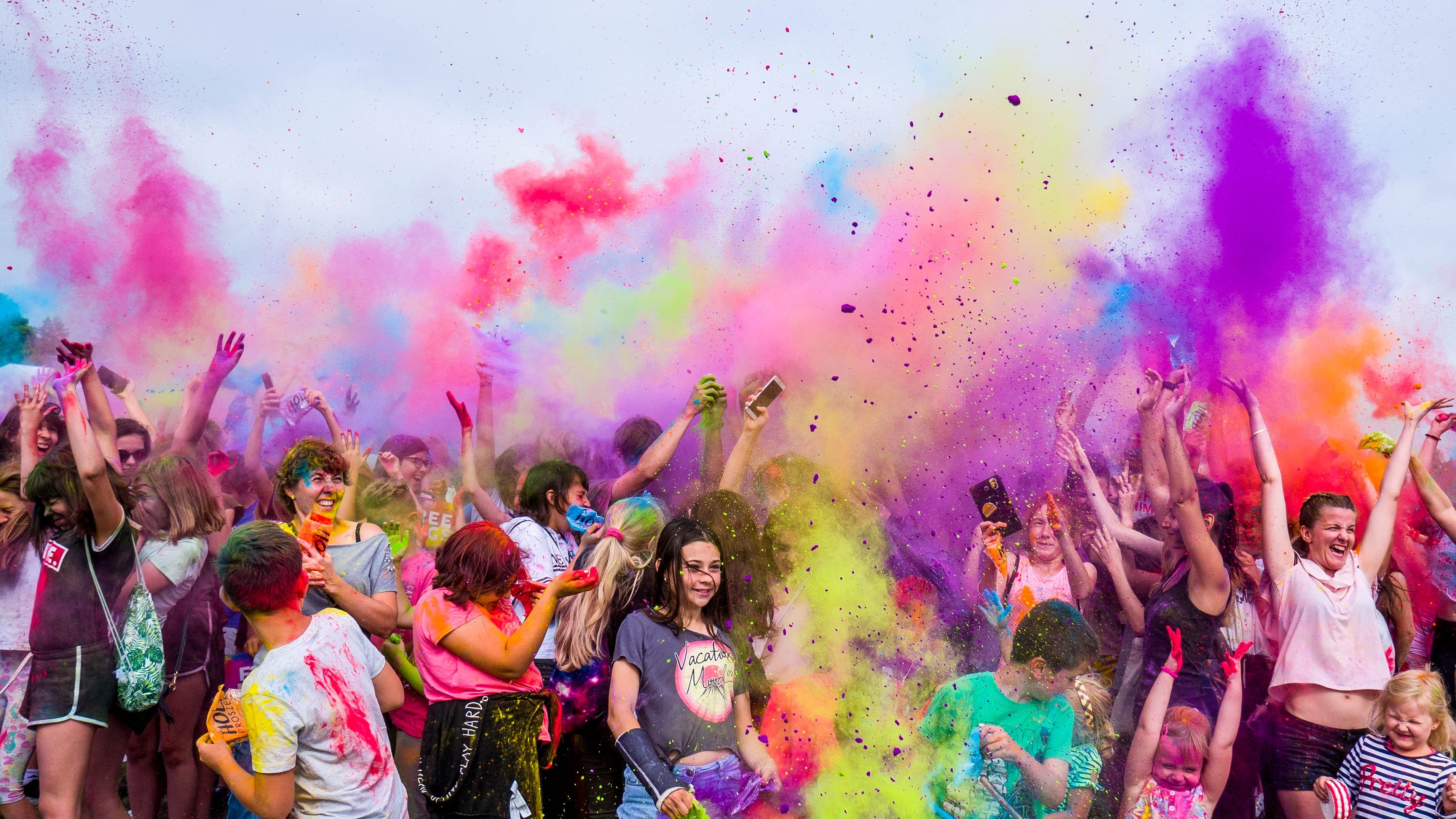 crowds of people throwing around paint powder to celebrate; Photo by Marcin Dampc from Pexels